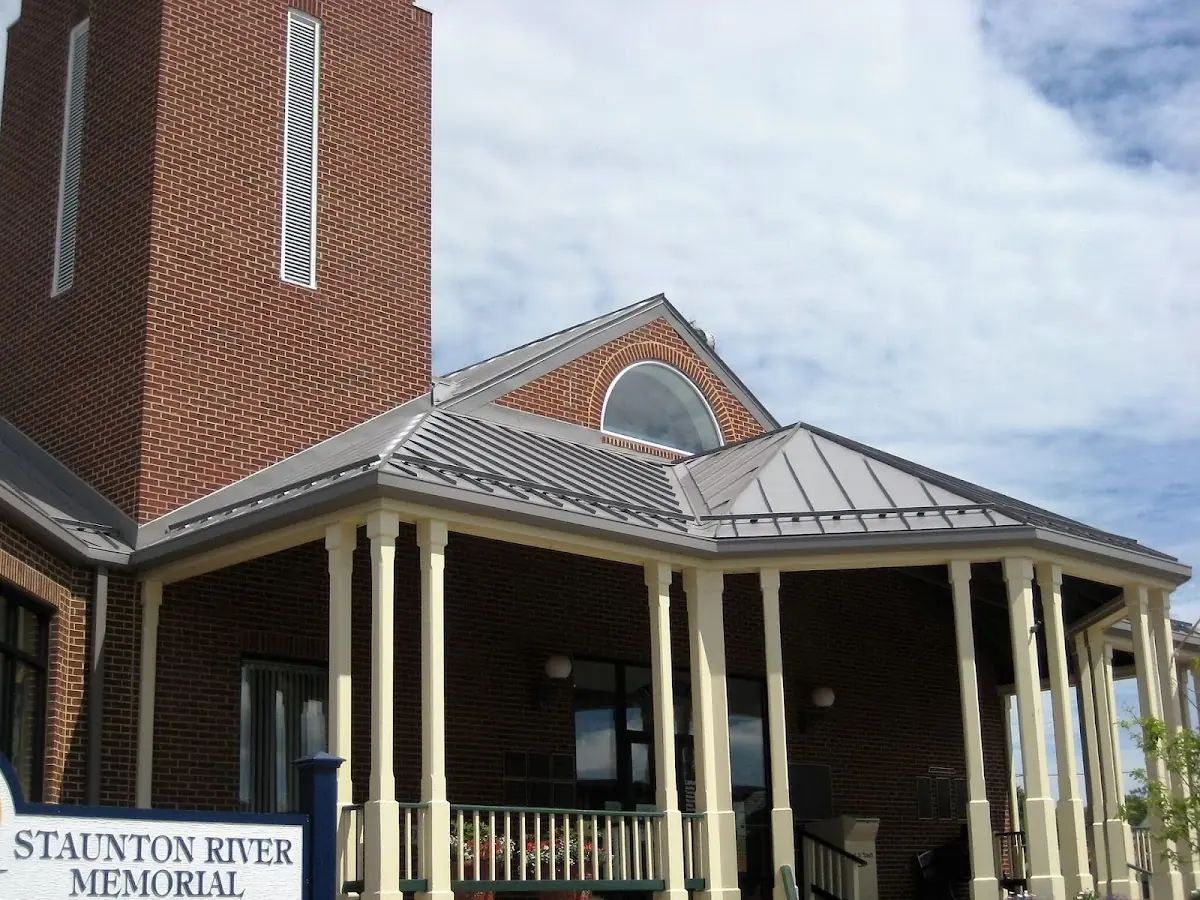 Skilled roofing craftsmen working on a residential roof in Rhoadesville